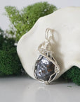 Left side detail of handmade raw sapphire necklace — artisan wire wrapped 925 sterling silver pendant, natural sapphire stone, ethically sourced crystal jewelry