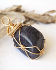 Right-angle detail of women's raw sapphire pendant showing artisan wire-wrapping in 14k gold-filled — handcrafted crystal necklace by Designs by Nature Gems