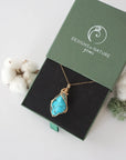 Raw turquoise necklace in 14k gold filled displayed in branded Designs by Nature Gems jewelry box. Artisan December birthstone gift for women.