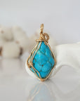 Back view of raw turquoise pendant in 14k gold filled, highlighting stone and wire detail. One of a kind December birthstone jewelry by Designs by Nature Gems.