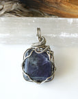 Back view of natural sapphire pendant showing the detail of dark silver wire-wrapping — one-of-a-kind handcrafted crystal jewelry