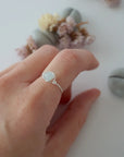 Minimalist silver aquamarine ring on female model's hand, handcrafted, Designs by Nature Gems