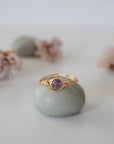 Front view of gold amethyst ring with polished 6mm natural amethyst bead, minimalist wire wrapped band
