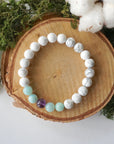 Bird’s eye top view of white howlite, amethyst, and amazonite stretch bracelet, calming crystal beaded bracelet for women