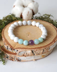 Full angled view of white howlite, amethyst, and amazonite stretch bracelet, natural gemstone beaded jewelry