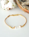 Bird’s-eye view of a women’s pearl and moonstone leather bracelet highlighting gemstone arrangement and leather cord