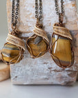 Three yellow tiger's eye pendants showing stone variation in size, shape, and colour — select your own pendant, one of a kind