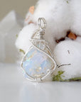 Detailed view of sterling silver opal pendant, artisan wire wrapped by Designs by Nature Gems.