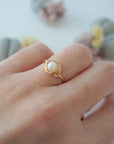 Minimalist 14k gold filled pearl wire wrapped ring worn on a model’s hand