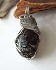 Front angle close-up of apache tears obsidian necklace – detailed artisan wire wrapping, natural volcanic glass, handcrafted pendant.