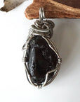 Back view of handcrafted apache tears obsidian pendant – natural volcanic glass and wire wrapping detail, Designs by Nature Gems.