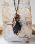 Back view of handcrafted blue tiger's eye necklace for men – natural stone and wire wrapping, antique bronze copper, masculine design.