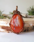 Front angle close-up of carnelian necklace – detailed artisan wire wrapping, natural raw carnelian, handcrafted Virgo birthstone pendant.