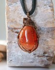 Handcrafted raw carnelian necklace for men, front view – artisan bronze copper wire wrapping, Virgo birthstone, black leather cord.