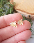 Natural citrine stud earrings held in hand showing size comparison - unisex raw crystal sterling silver studs
