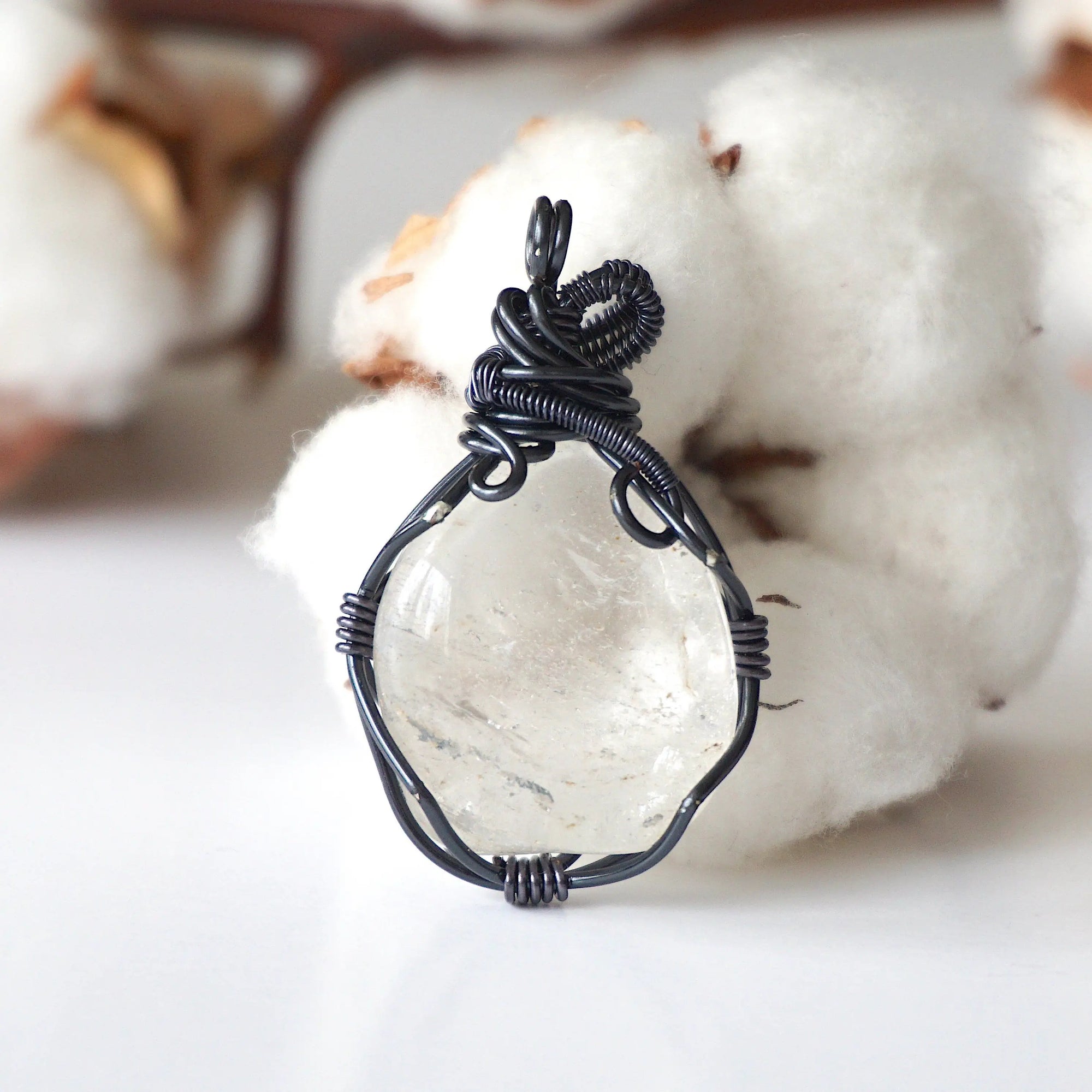 Back view of handcrafted clear quartz pendant – natural stone and detailed wire wrapping, April birthstone.