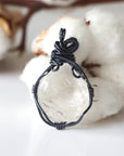 Back view of handcrafted clear quartz pendant – natural stone and detailed wire wrapping, April birthstone.