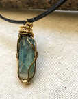 Left angle close-up of green kyanite necklace for men – highlighting unique wire-wrapped artistry, green kyanite, antique bronze and gold copper.
