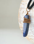 Left angle close-up of lapis lazuli point necklace for men – highlighting unique wire-wrapped artistry, blue lapis lazuli, antique bronze copper.