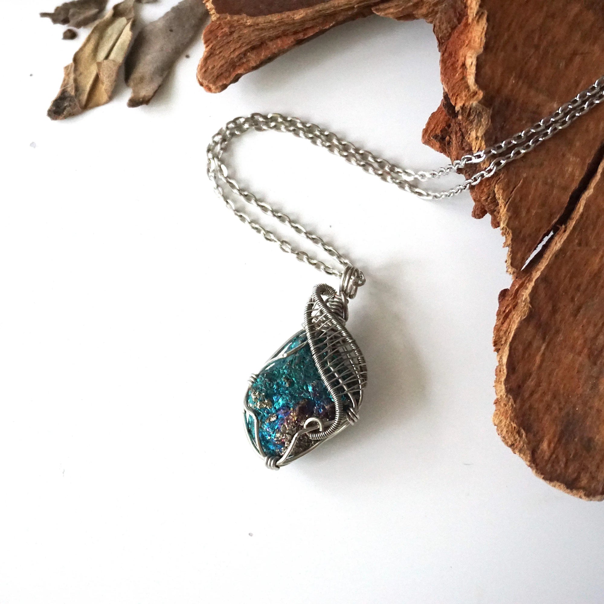 Handcrafted peacock ore necklace for women, laying flat on white gold chain – artisan wire wrapped, Capricorn and Cancer birthstone, natural crystal pendant.