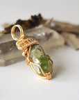 Right angle detail of raw peridot necklace for women – highlights artisan gold copper wire wrapping and organic stone texture.