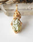 Back angle view of raw peridot necklace for women – showcases wire wrapping and natural stone matrix.