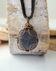 Back view of handcrafted men's sapphire necklace – natural stone and wire wrapping, September birthstone, black leather cord.