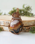 Front angle close-up of sardonyx necklace – detailed artisan wire wrapping, natural banded sardonyx, handcrafted August birthstone pendant.
