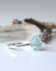 Right angle view of adjustable aquamarine ring, highlighting prong setting and raw gemstone, 925 sterling silver