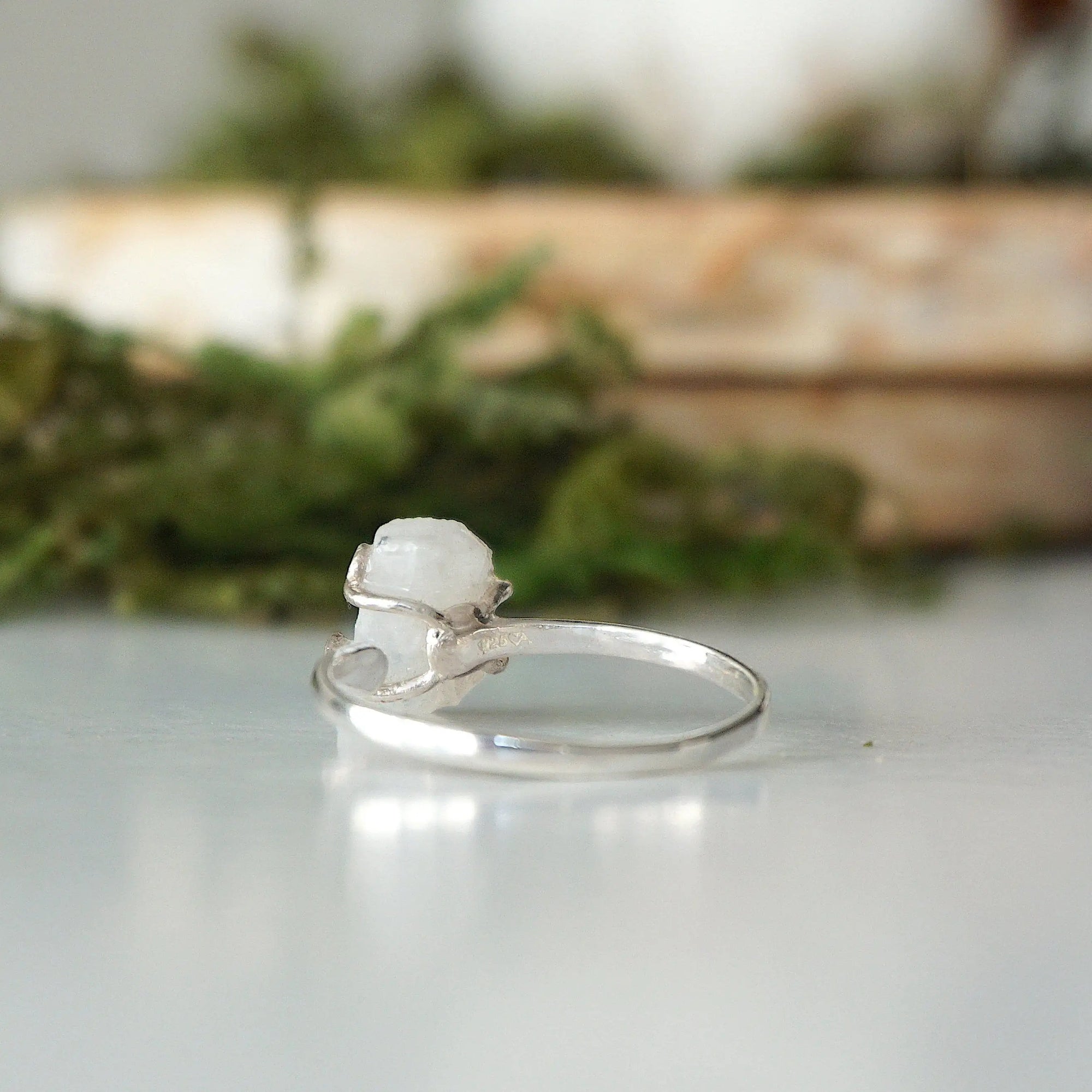 Back view of adjustable ring band in 925 sterling silver showing open adjustable fit and handcrafted finish on rainbow moonstone ring.