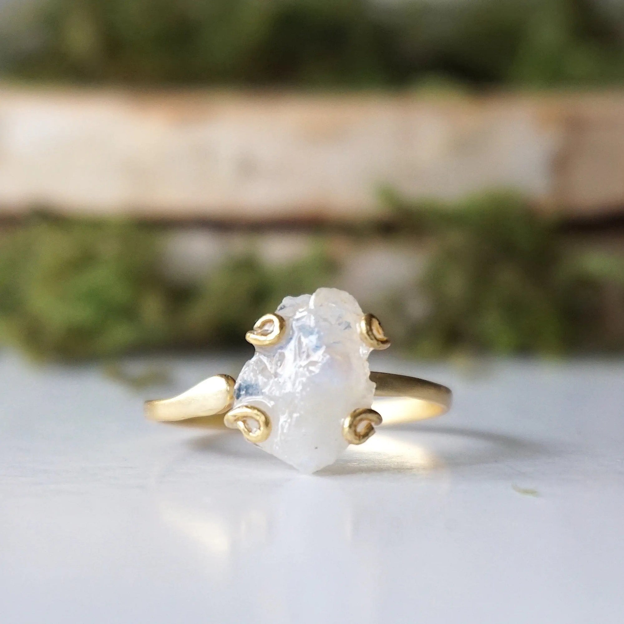 Close-up front view of raw rainbow moonstone stone in artisan 14k gold vermeil adjustable ring setting, June birthstone ring.