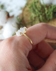 Lifestyle photo of adjustable raw rainbow moonstone ring in 14k gold vermeil on a woman’s hand, minimalist June birthstone jewelry.