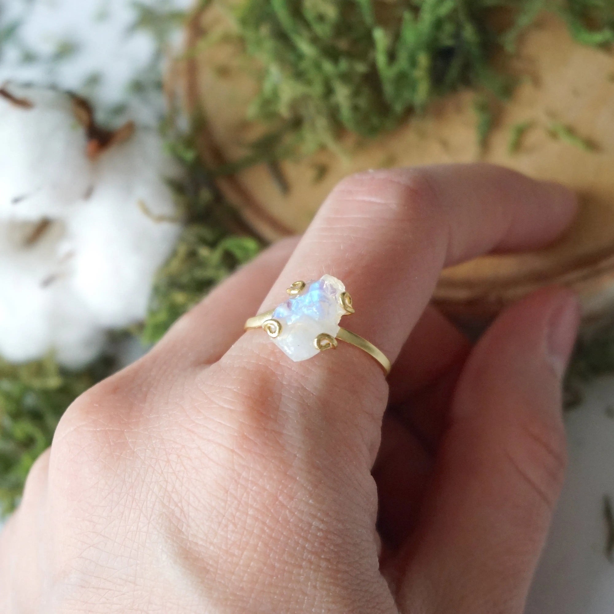Adjustable raw rainbow moonstone ring on hand in 14k gold vermeil setting, natural moonstone flash, June birthstone ring for women.