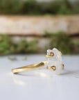 Right side angle close-up of adjustable raw rainbow moonstone ring showing gold vermeil prongs and natural stone shape.