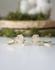 Two adjustable raw rainbow moonstone rings showing natural variation in stone size, shape, and moonstone flash in gold vermeil settings.