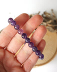 Amethyst beaded stretch bracelet in hand for size reference, natural 8mm amethyst beads
