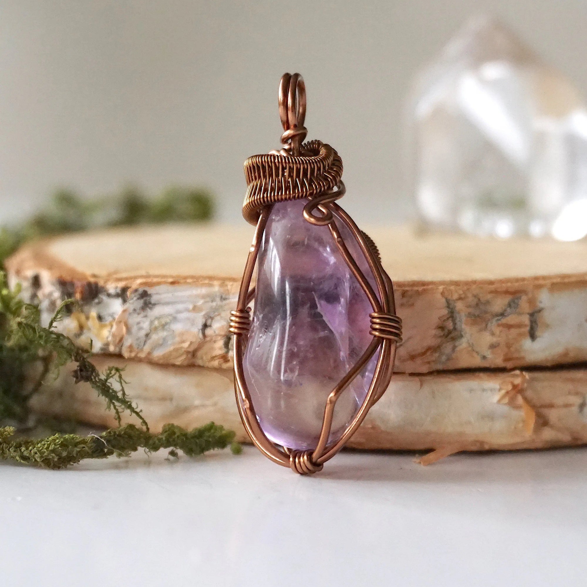 Front side angle of women’s amethyst pendant, lighter violet stone, antique bronze copper wire wrap
