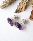 Top view of amethyst stud earrings, natural dark amethyst stones and sterling silver posts