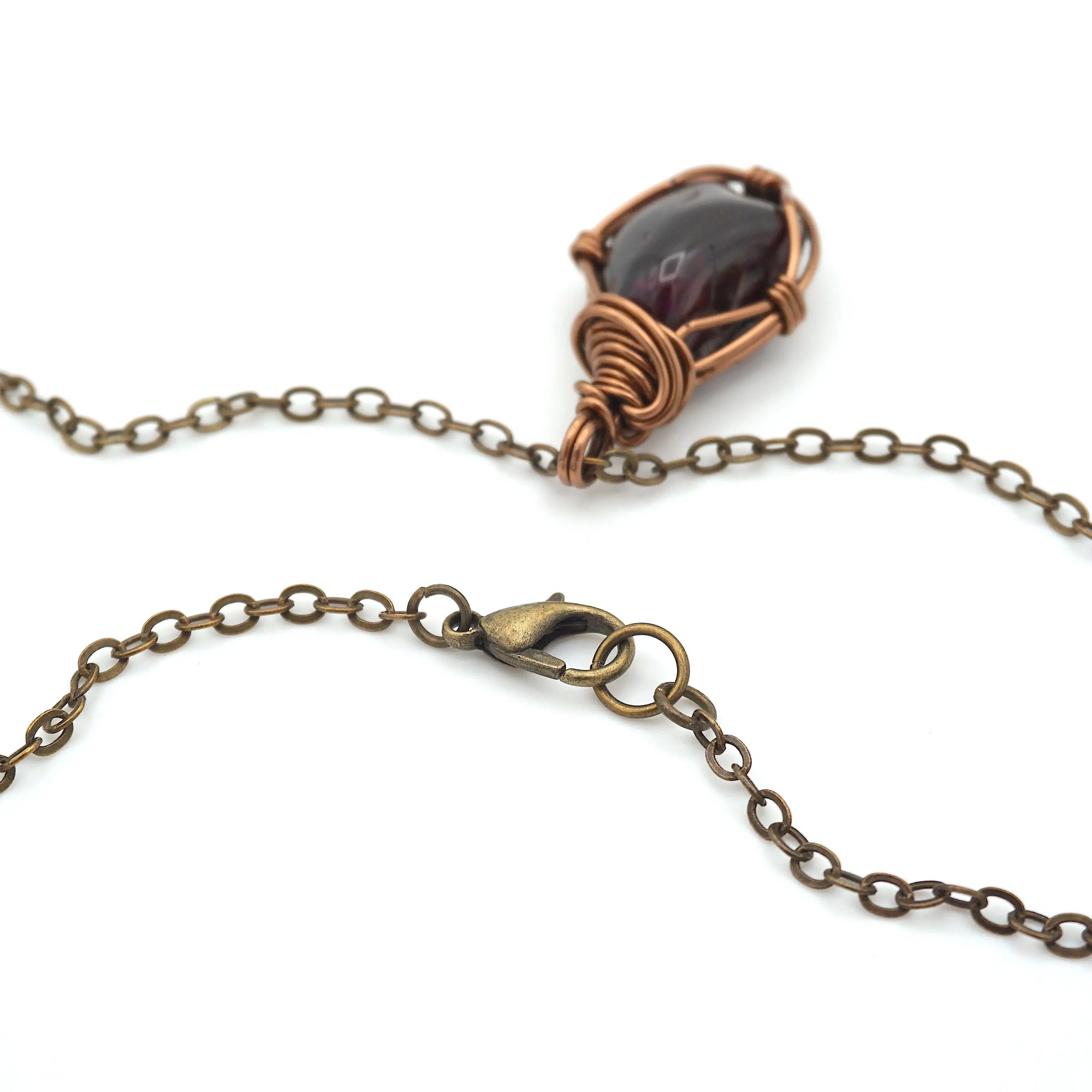 Close up of antique bronze copper chain lobster claw closure for natural garnet necklace