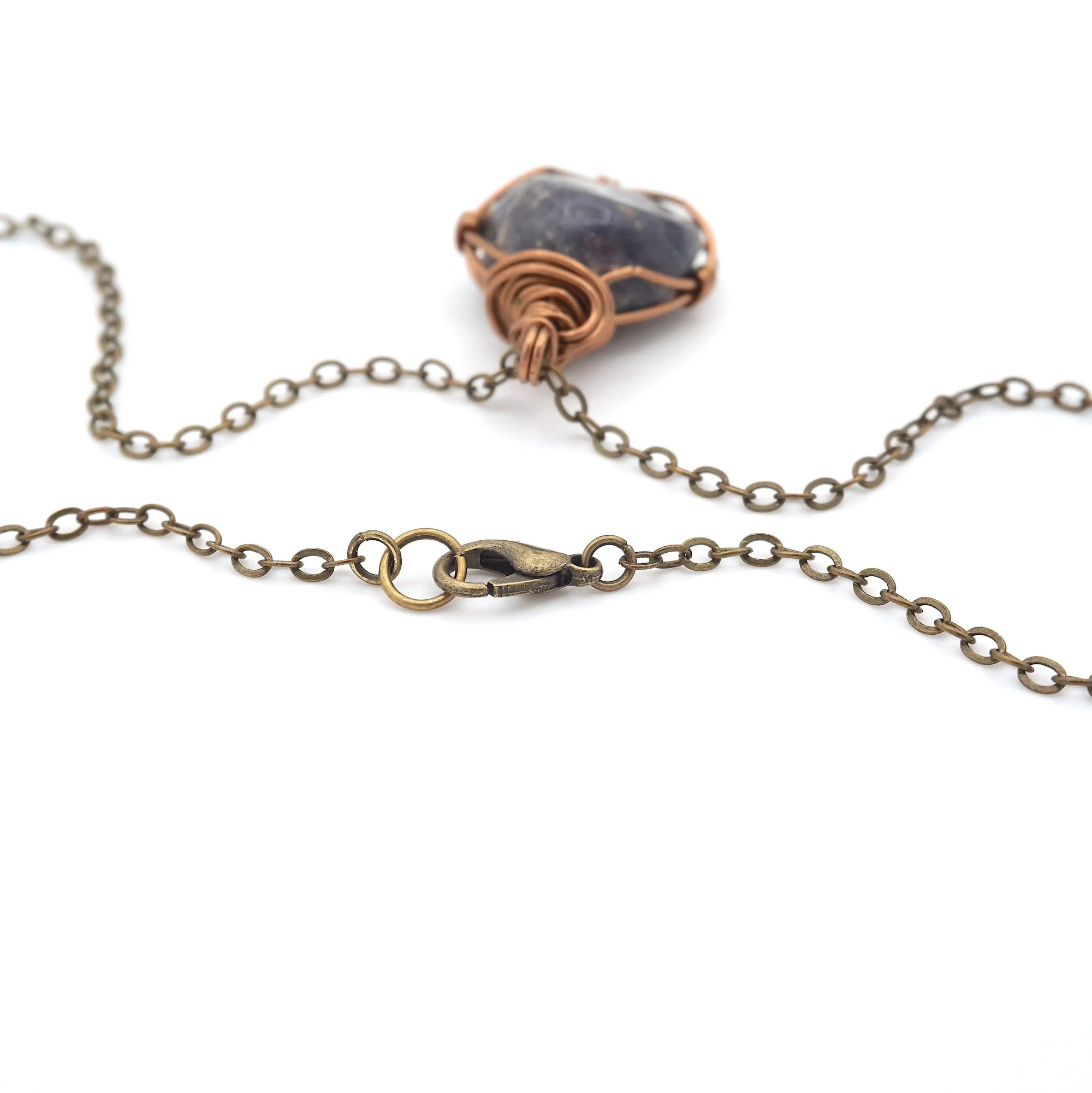 Close-up of antique bronze lobster clasp chain closure on a handcrafted raw sapphire necklace by Designs by Nature Gems