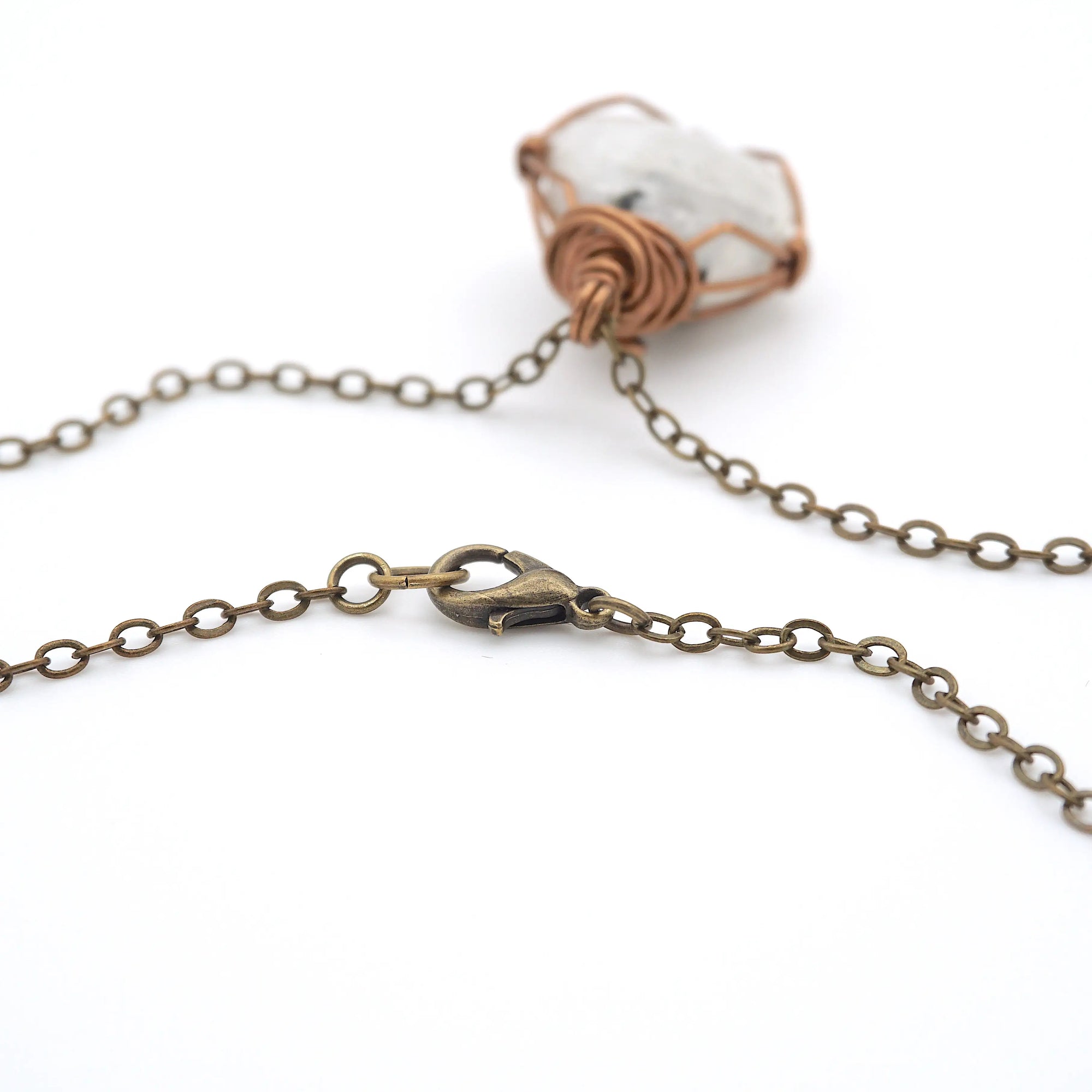 Close-up of antique bronze cable chain with lobster clasp closure on handmade rainbow moonstone necklace