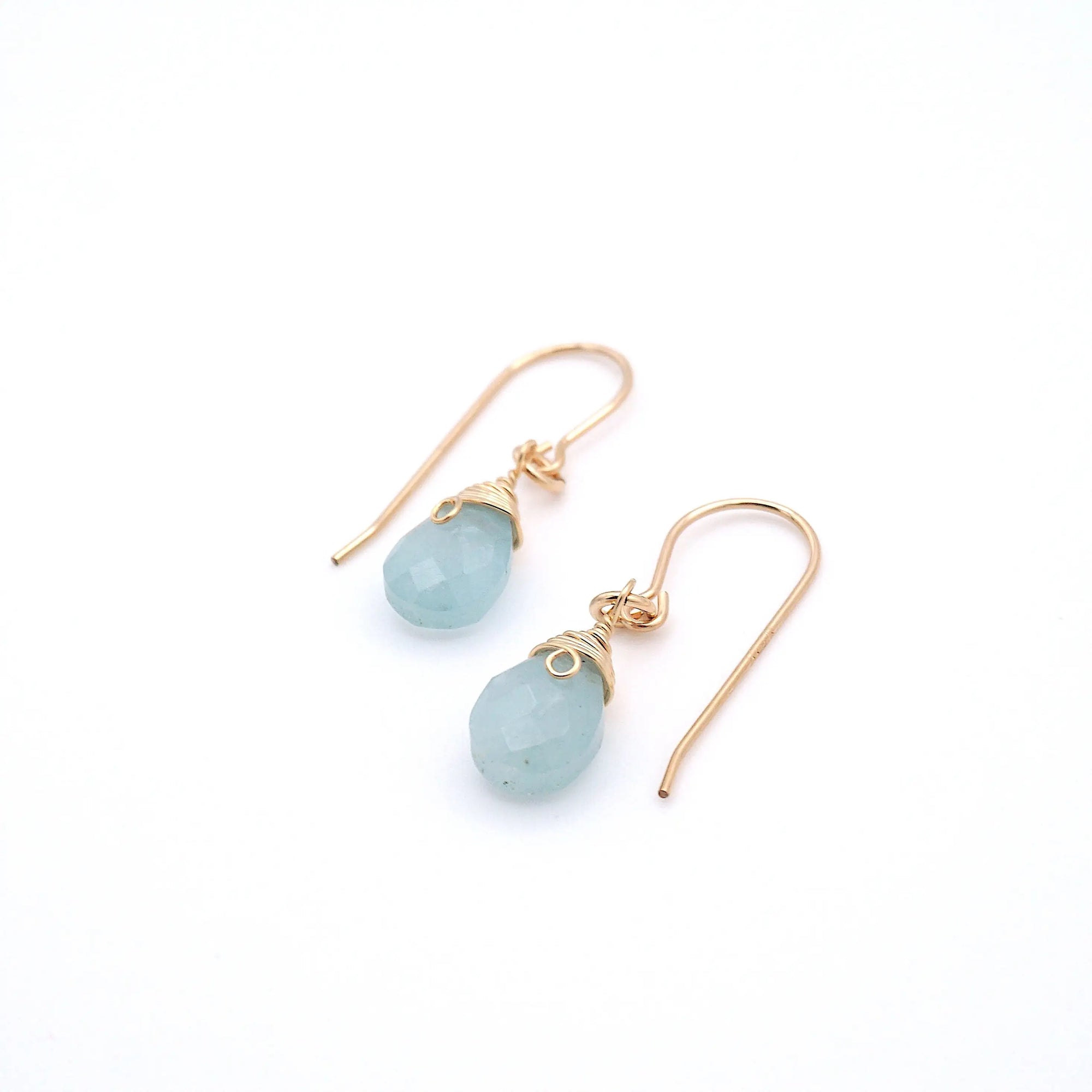 Angled view of aquamarine drop earrings, showing detailed wire wrapping and faceted aquamarine, 14k gold filled