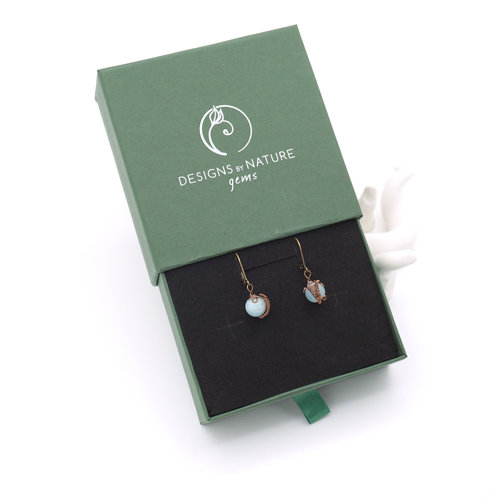 Aquamarine drop earrings presented in a branded gift box, ready for gifting, with antique bronze copper wire wrapping.