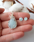 Aquamarine jewelry set with artisan wire wrapped necklace and stud earrings in a hand for size reference, genuine aquamarine, Designs by Nature Gems