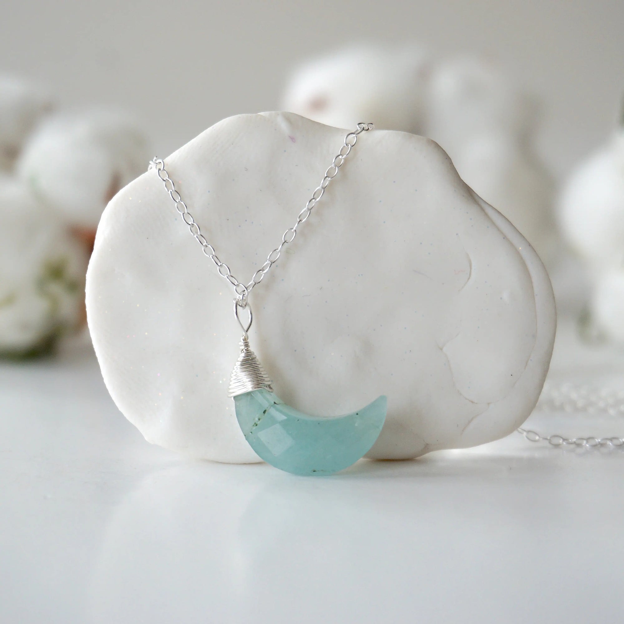 Detailed front view of aquamarine moon necklace for women, minimalist artisan wire wrapping in sterling silver, Designs by Nature Gems