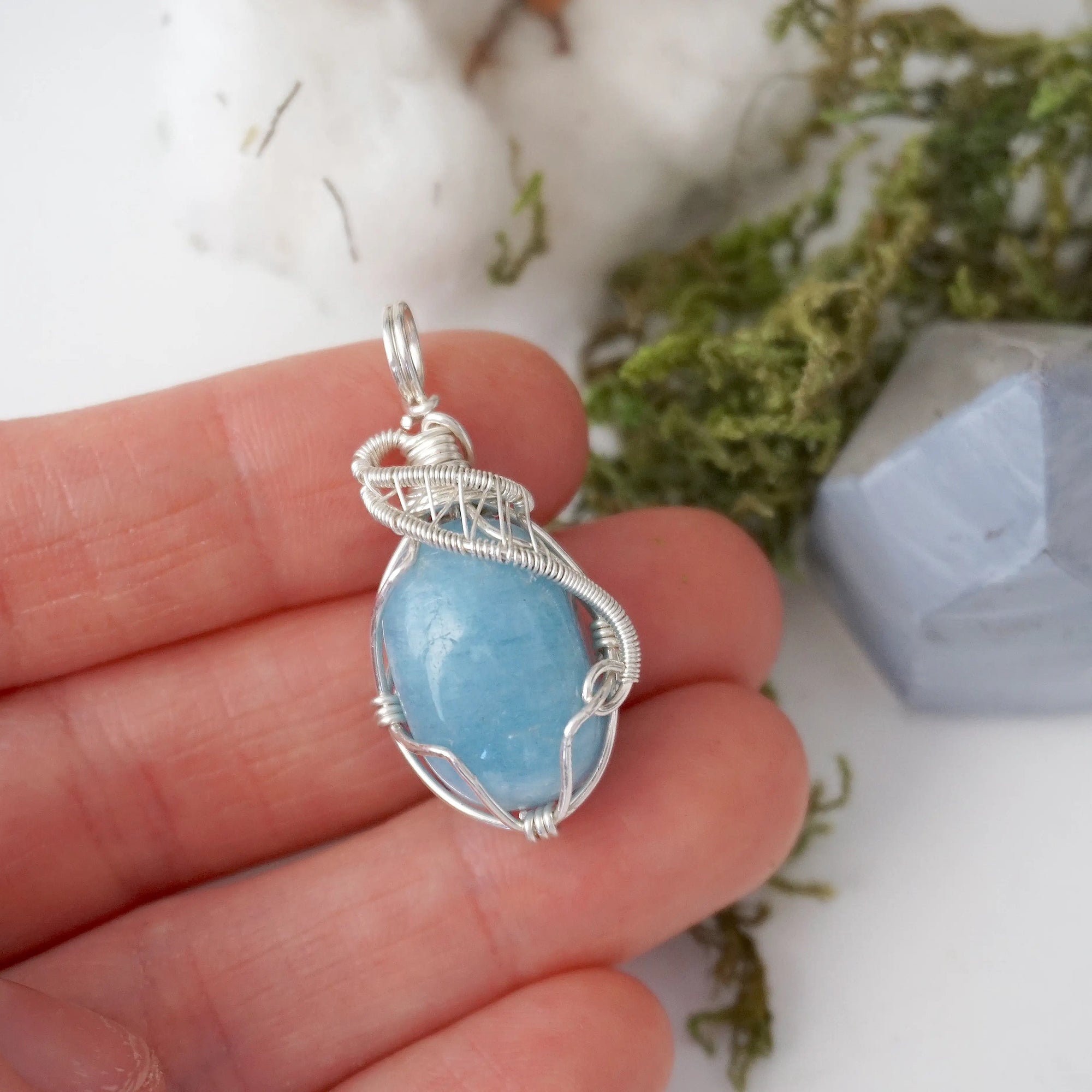 Aquamarine necklace in hand for size reference, artisan wire wrapped, March birthstone jewelry