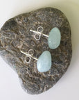 Top angle of aquamarine stud earrings with sterling silver posts, showing raw stone texture