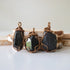 Three raw black tourmaline pendants showing natural stone variation in size and shape, artisan jewelry by Designs by Nature Gems.