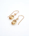 Angled look at citrine drop earrings, artisan wire wrapping in 14k gold filled, November birthstone