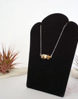 Left side angle of citrine pearl bar necklace showing horizontal pendant and sterling silver 925 chain - natural crystal freshwater pearl wire wrapped necklace full view